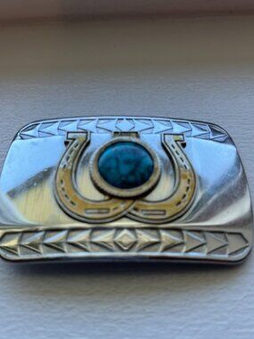 Western style belt buckle horseshoe design.